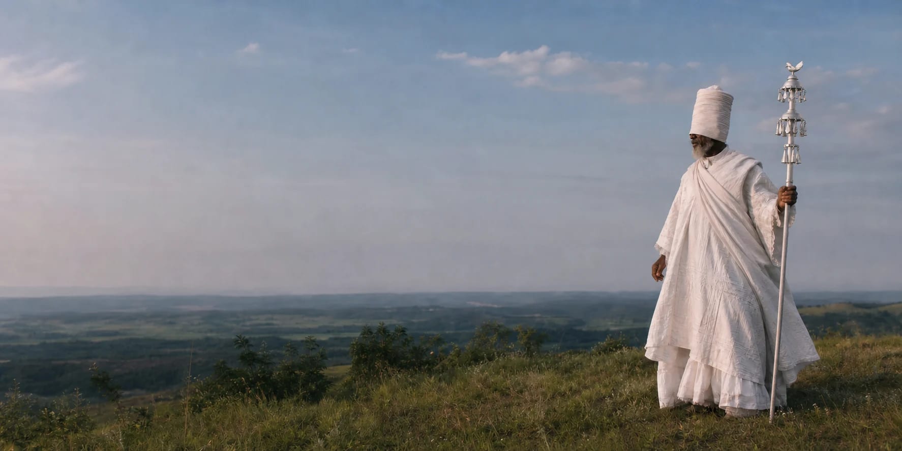 Oxalá em vestes brancas diante de um horizonte aberto, segurando seu cajado cerimonial